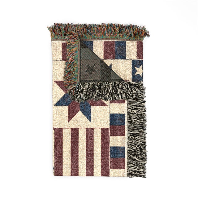 This Americana star woven throw blanket features vintage quilt-inspired patchwork, stars, and stripes in muted navy,...