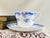 This vintage fine bone china footed teacup and saucer set was crafted by Shelley in Staffordshire, England. It features...