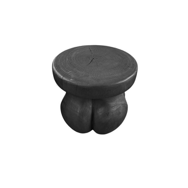 Crafted from solid mango wood, this sculptural side table showcases a bold organic form defined by its rounded, flowing...