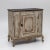 Single-door Baroque half cabinet featuring a serpentine carved apron and legs adorned with volute motifs. The body is...