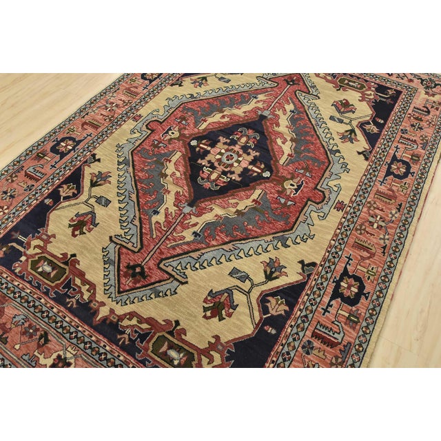 An authentic vintage traditional Heriz rug hand-knotted with fine wool on a cotton foundation. This rug features a central...