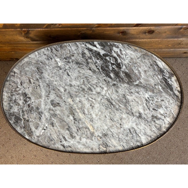 This gorgeous coffee table was made in France sometime around 1950. It's done in the Louis XVI style that features...