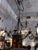 Design Plus Gallery presents a Scrolling Iron Like Chandelier. The frame is formed in black painted metal with sweeping...