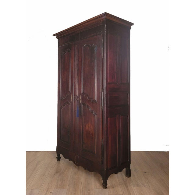 A large Louis XVI–style walnut armoire, France circa 1840.