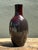 This striking vintage studio pottery vase exhibits a sophisticated balance of sleek form and rich, moody color. The hand-...