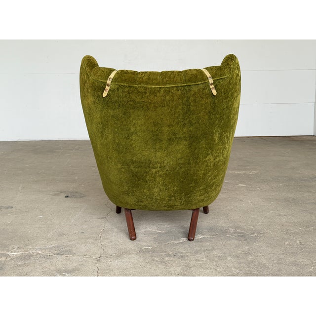 A teak and velvet lounge chair in the Danish Modern tradition, designed by Svend Skipper as Model 91, known in Denmark as...