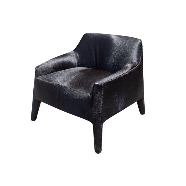 A "Murphy" black hair on hide armchair by Verellen. This chair has a low backrest and arms and a wide seat. The underside...
