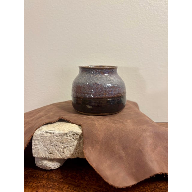 Vintage 1980s American studio pottery vase with a wonderfully earthy, hand-thrown form and expressive layered glaze. The...