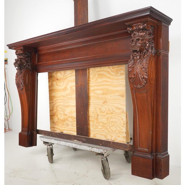 Antique Renaissance Revival fireplace mantel made of a dark stained wood with carved lion heads on each side. Good antique...