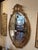 Lovely oval giltwood French style mirror having beveled mirror.