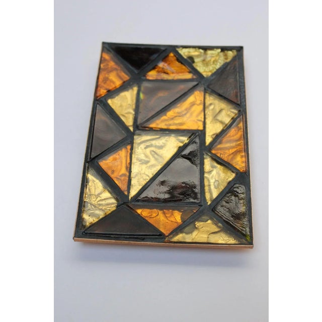 Small trinket tray composed of cut and inlaid mosaic glass triangles in deep amber (almost black) yellow and orange with a...
