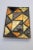 Small trinket tray composed of cut and inlaid mosaic glass triangles in deep amber (almost black) yellow and orange with a...