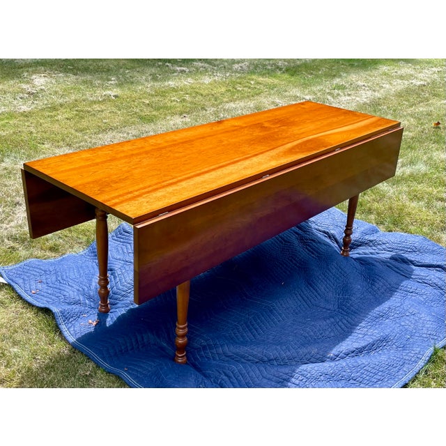 Up for sale is an exceptional, authentic mid-century modern American Colonial Revival solid cherry wood harvest dining...