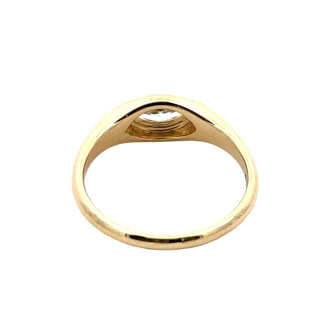 Refined 18K yellow gold signet ring showcasing a single marquise-cut diamond totaling approximately 0.58 carats in a...