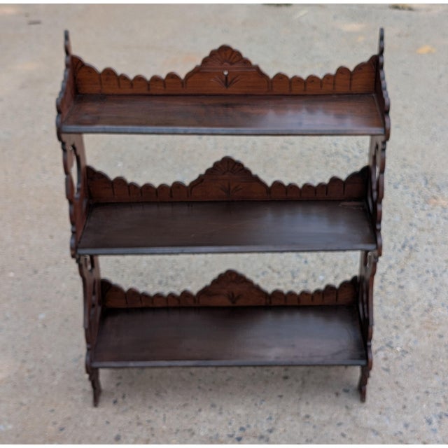 Exuding authentic 19th-century charm, this antique Victorian mahogany wall-hanging shelf unit features three spacious...