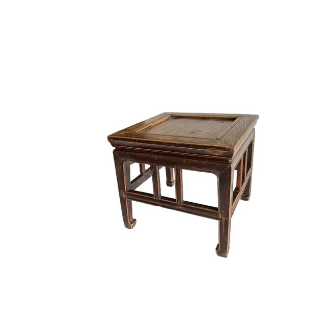 The mastery of the Chinese furniture maker shows off on this simple square stool. It has a wide mitered frame, waisted...