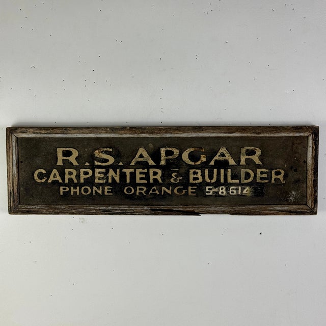 A unique and early 20th Century hand painted on metal with wood frame trade sign. It advertised "R.S. Apgar Carpenter &...