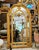 Make a grand statement with this ornate French Rococo-style wall mirror, featuring a lavish frame finished in gold leaf...