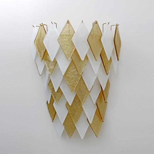 Pair of wall lamps, each composed of 35 gold and white Murano blown glass rhombuses. The lamps have six E14 lamp holders...
