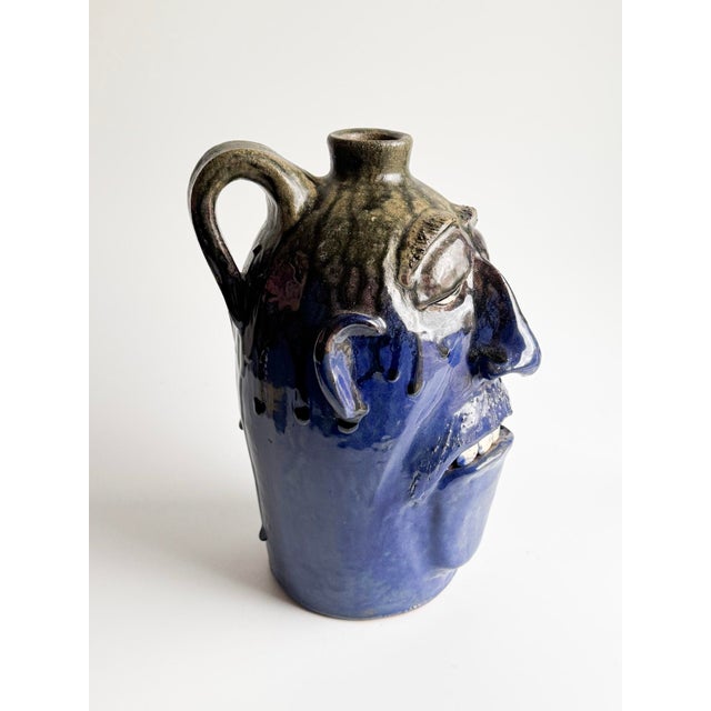 Powerful vintage ceramic face jug created by Dal Burtchaell, a maker associated with Georgia Folk Pottery traditions. This...
