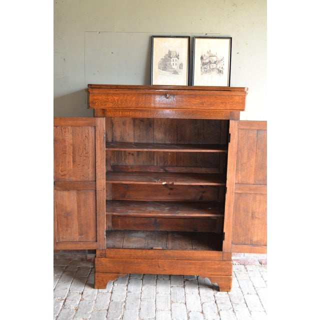 of a 19th-century French oak Louis Philippe maid's cabinet. The height is 148 cm. The width is 107 cm. The depth is 45 cm....