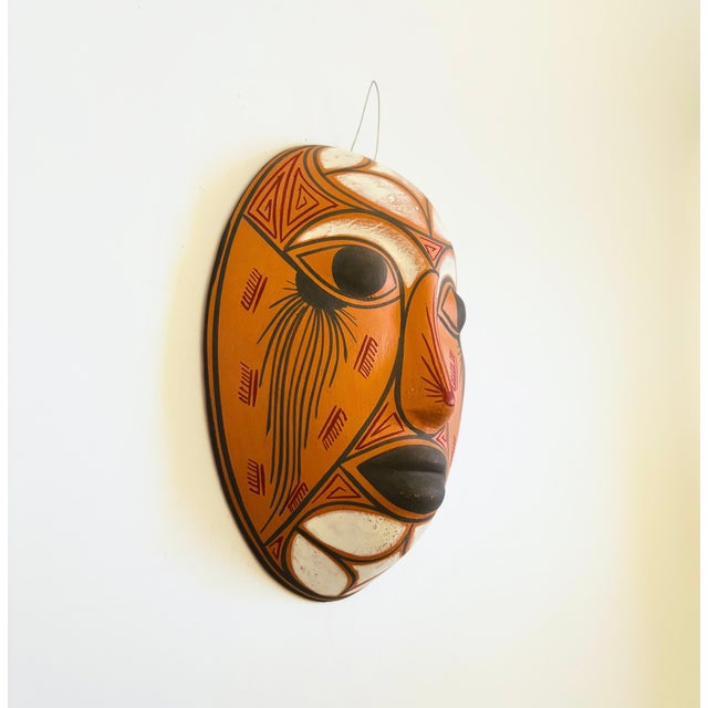 A wonderful vintage terra cotta pottery mask wall hanging. Natural unglazed finish with beautiful hand painted designs...