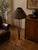 Elegant floor lamp featuring a sculptural wrought iron frame paired with a beautifully handwoven bamboo shade. Dating from...