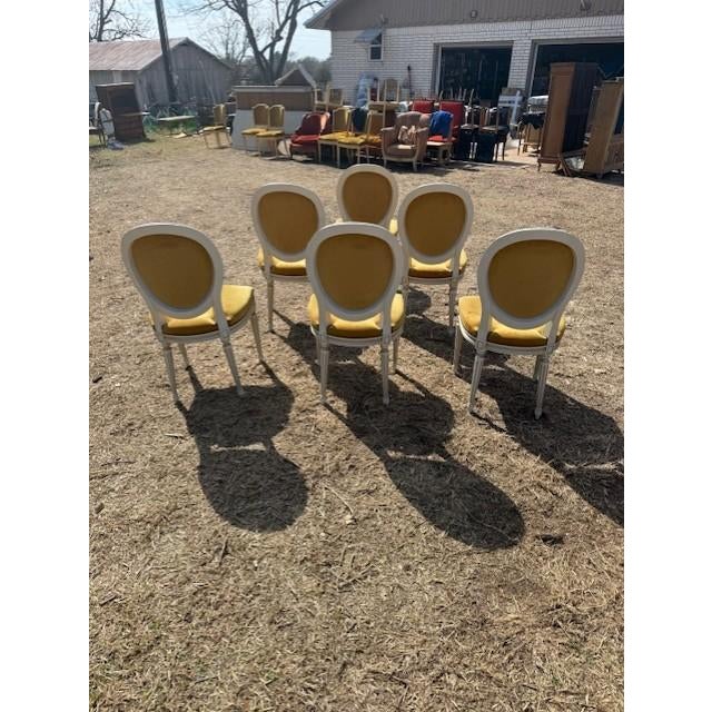 A set of six 19th century Louis XVI-style dining chairs featuring classic oval "medallion" backs, fluted tapered legs, and...