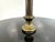 A thoughtfully designed early to mid 20th century floor lamp featuring a turned wood base, aged brass stem, and an...