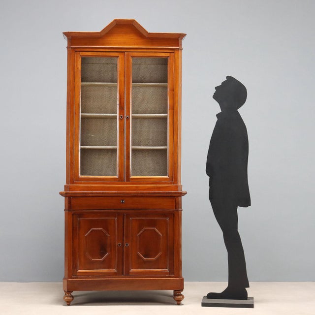 Umbertino walnut cupboard. Glass-door cabinet with three internal shelves, a drawer in the lower section, and a pair of...