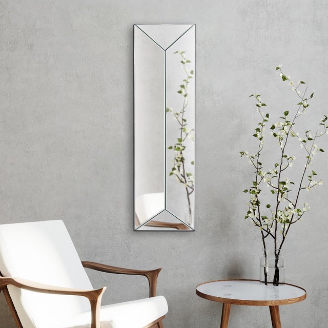 The Vertex Mirror Panel features beveled glass and angled sides that meet at a raised center, creating a striking 3D...