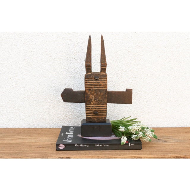 This antique tribal door lock, hand-carved from wood in Mali, Africa, is more than just a functional object; it's a...