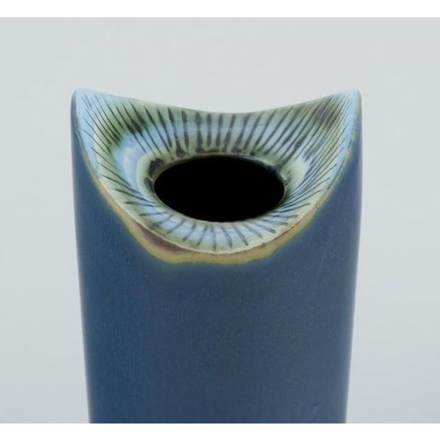 Lisa Larson for Gustavsberg, Sweden. Modernist ceramic vase in blue glaze. Cylindrical shape. 1960/70s. Hand painted....
