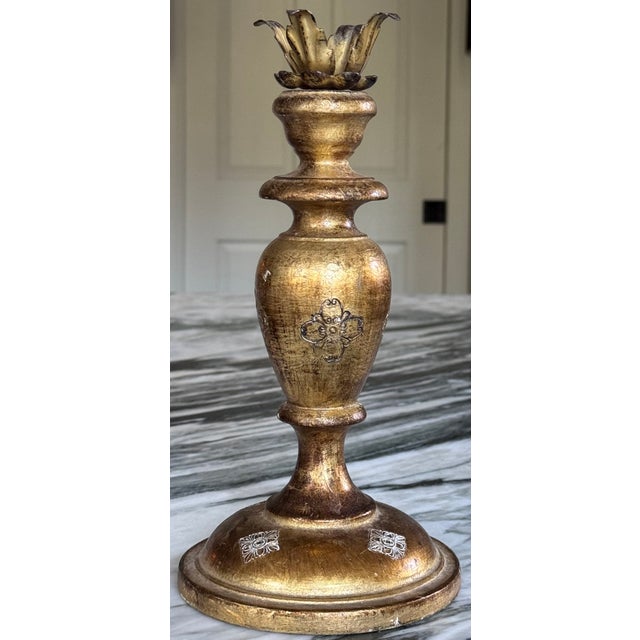 Classically styled gold giltwood embossed with center motifs as well as repeating decor on the base. Best suited to hold a...