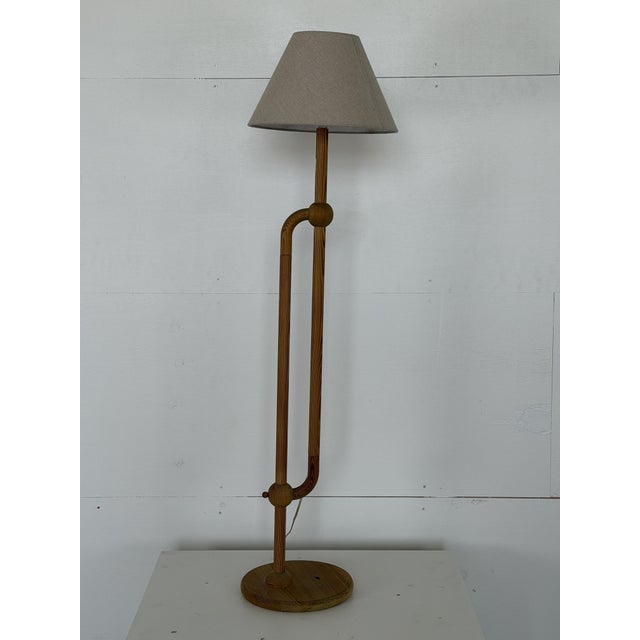 This floor lamp is Swedish in origin and dates from the 1970s. The solid pine frame is built from turned rods bent into a...