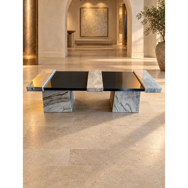 A one-of-a-kind, handcrafted coffee table combining natural Rhino quartzite with polished black porcelain. Three raised...