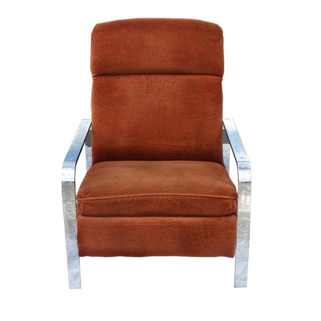 A mid century modern recliner designed by by the Design Institute of America. A flatbar chrome frame with reddish-orange...