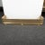 Perforated brass fireplace fender with cast animal foot and rope details.
