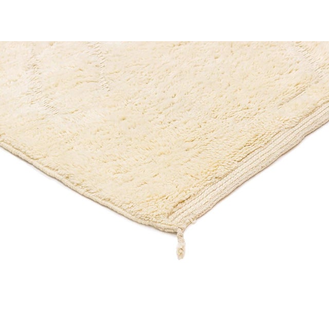 Balanced proportions, whispered lines: a soft ivory canvas with a quiet handwoven story. A soft ivory field fills this...