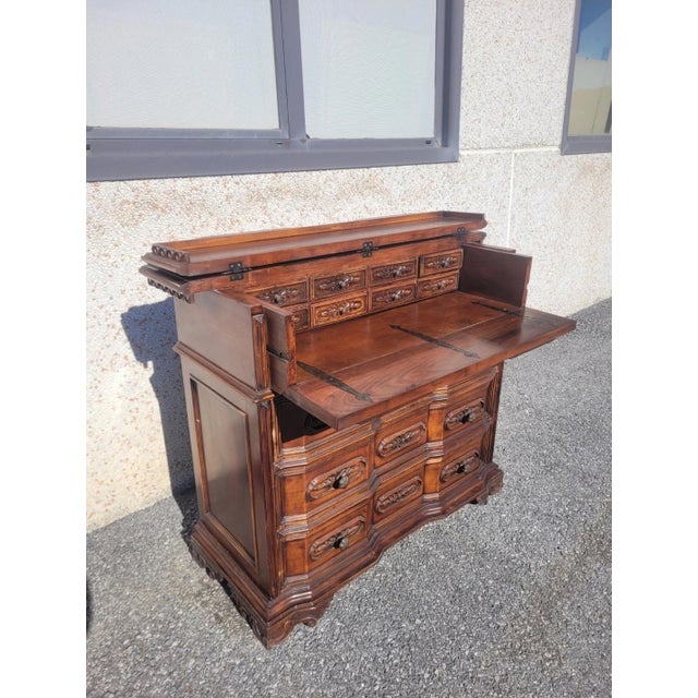Baroque-style carved chest of drawers with writing desk. Removable top, 8 drawers inside. The front panel features three...
