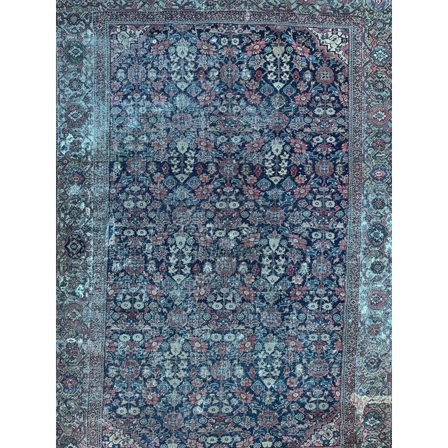 Exquisite late 19th-century distressed Farahan rug featuring a captivating « Herati » design with stylized flowers on a...
