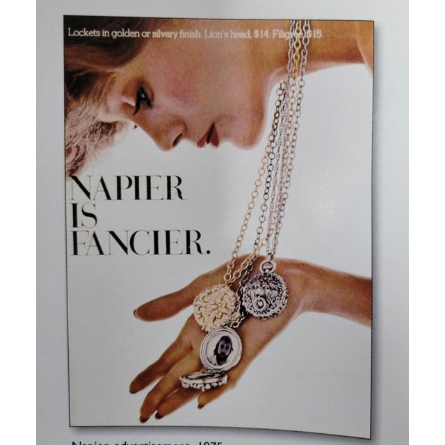 Victorian style goldtone pocket watch style floral design locket pendant on a chain necklace with spring ring clasp. One...