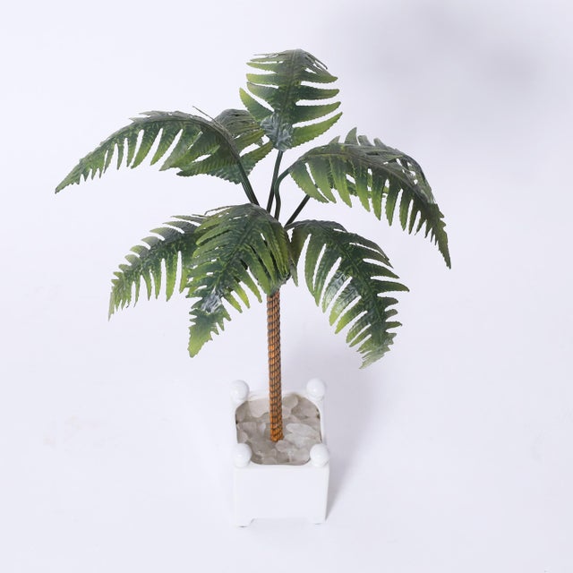 Chic vintage Italian palm tree object of art having tole leaves on a brass trunk in a classical porcelain planter with...