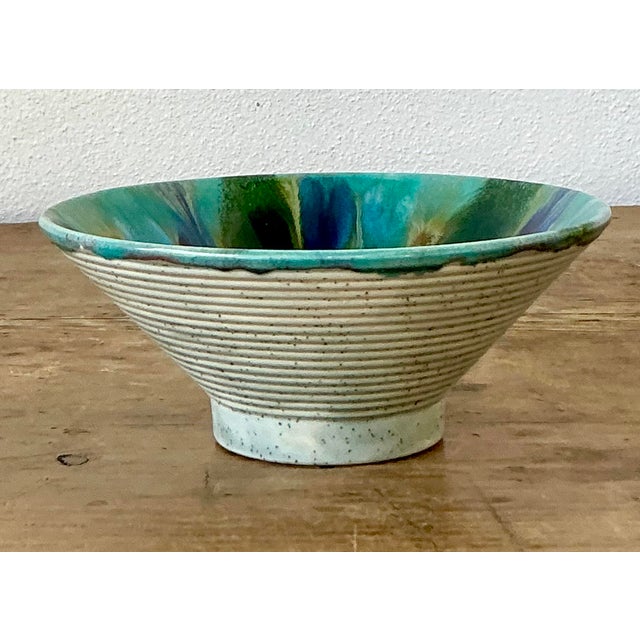 This vibrant set of three original studio pottery bowls is a masterful celebration of 1970s organic modernism. Each bowl...