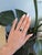 A GIA-certified Ceylon sapphire anchors this cushion-cut ring, its rich blue wrapped in a brilliant halo of diamonds and...
