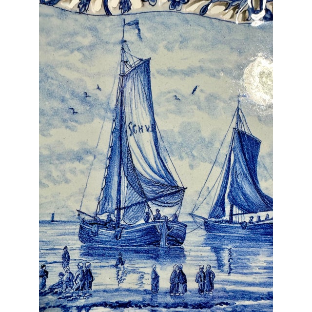 Very fine 19th century Delft reticulated dish, decorated with a coastal scene of fishermen and ships gathering at the...