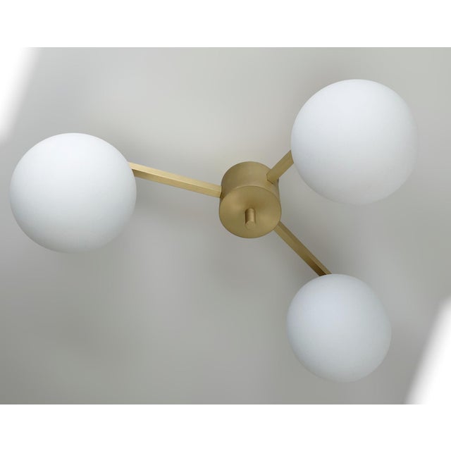 Italian flush mount with three matte white Murano glass globes mounted on solid brass frame in satin brass finish / Made...