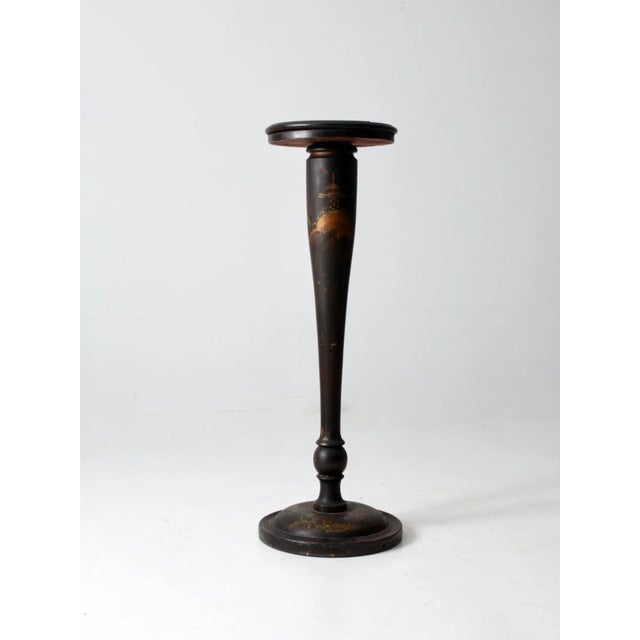 An elegant late 19th-century pedestal stand with a tall, tapered wood column, turned details and a rich dark finish. Hand-...