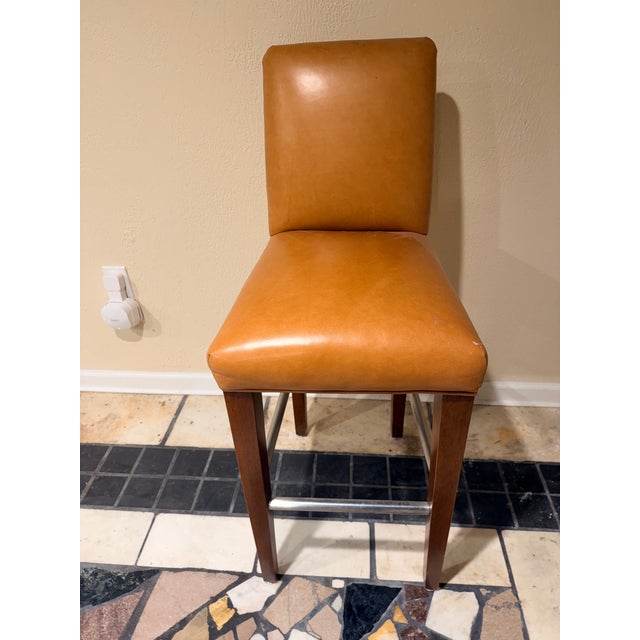 These elegant armless faux tan leatherette counter bar stools by R Jones of Dallas, Texas have a modern touch with an...
