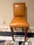 These elegant armless faux tan leatherette counter bar stools by R Jones of Dallas, Texas have a modern touch with an...